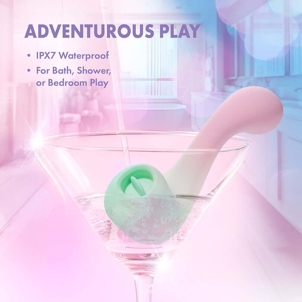 Play With Me Massager Melody Pink in a martini glass, showcasing IPX7 waterproof for adventurous play.