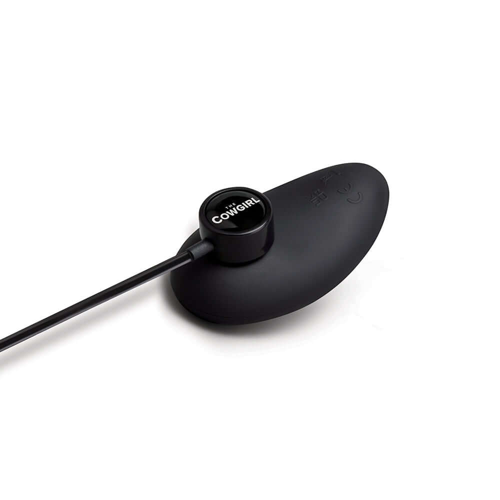 The Cowgirl Saddle Machine Black attachment with sleek design and control button.