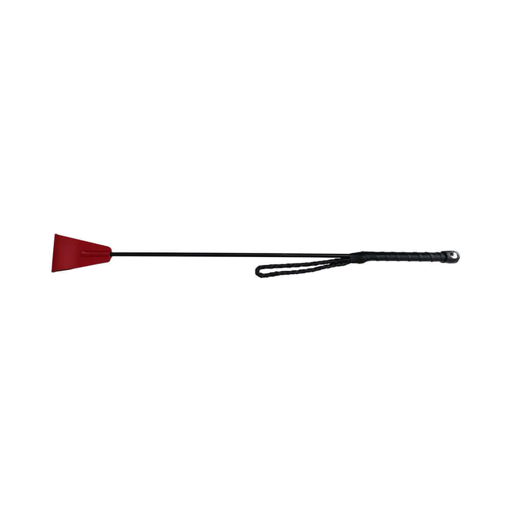 Rouge Fetish Play Vegan Riding Crop Red resting on a flat surface, showcasing its sleek design and sturdy construction.