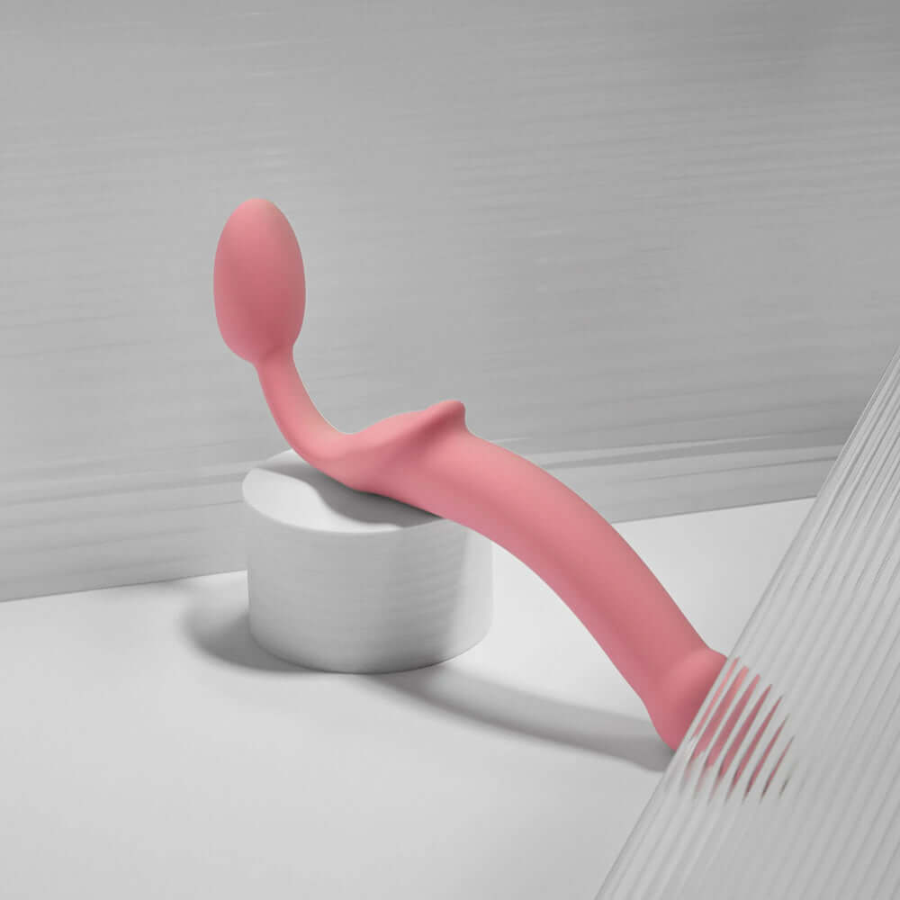 Strap-On-Me Silicone Bendable Strapless Pink Small displayed on a surface, showcasing its ergonomic design for comfort.