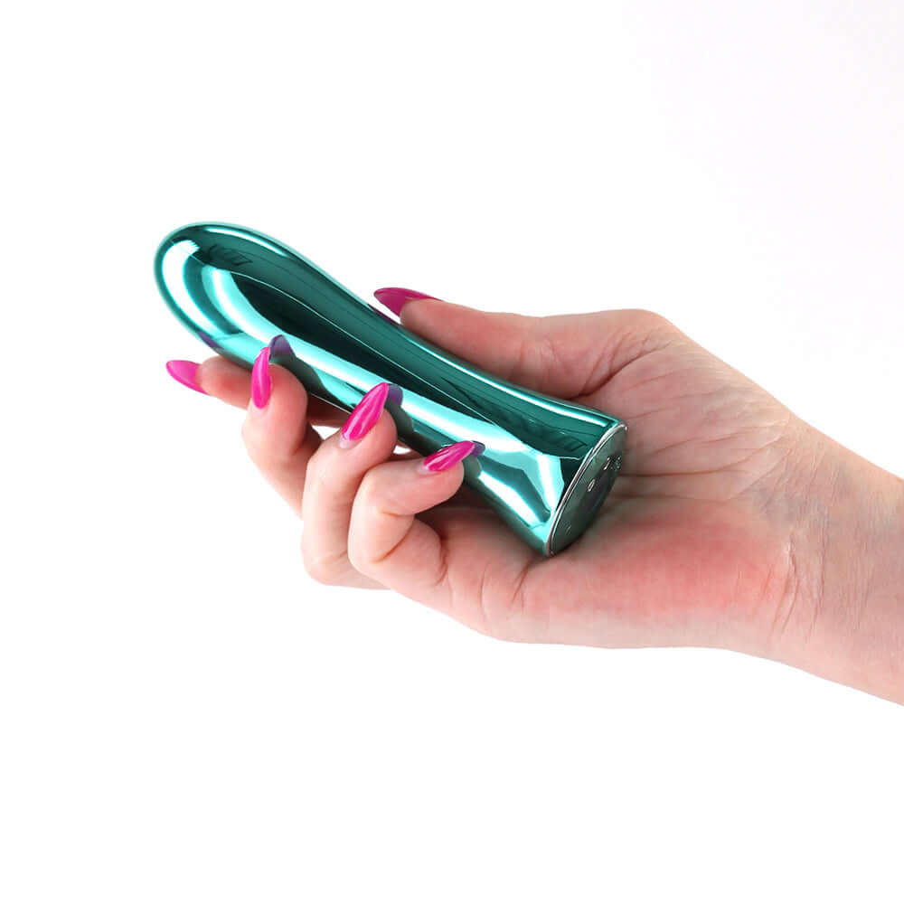 Hand holding the INYA Shimmer Metallic Vibrator Aqua with a sleek metallic finish and vibrant design.