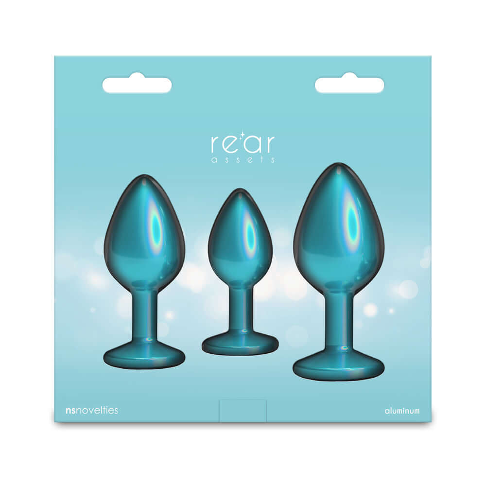 Rear Assets Trainer Metal Plug Kit Iridescent Teal packaging with three chrome-plated plugs for anal training.