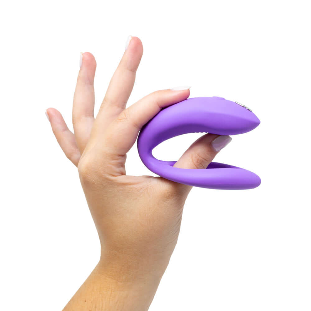 We-Vibe Sync O Vibrator Light Purple held in a hand showing its design and flexibility.