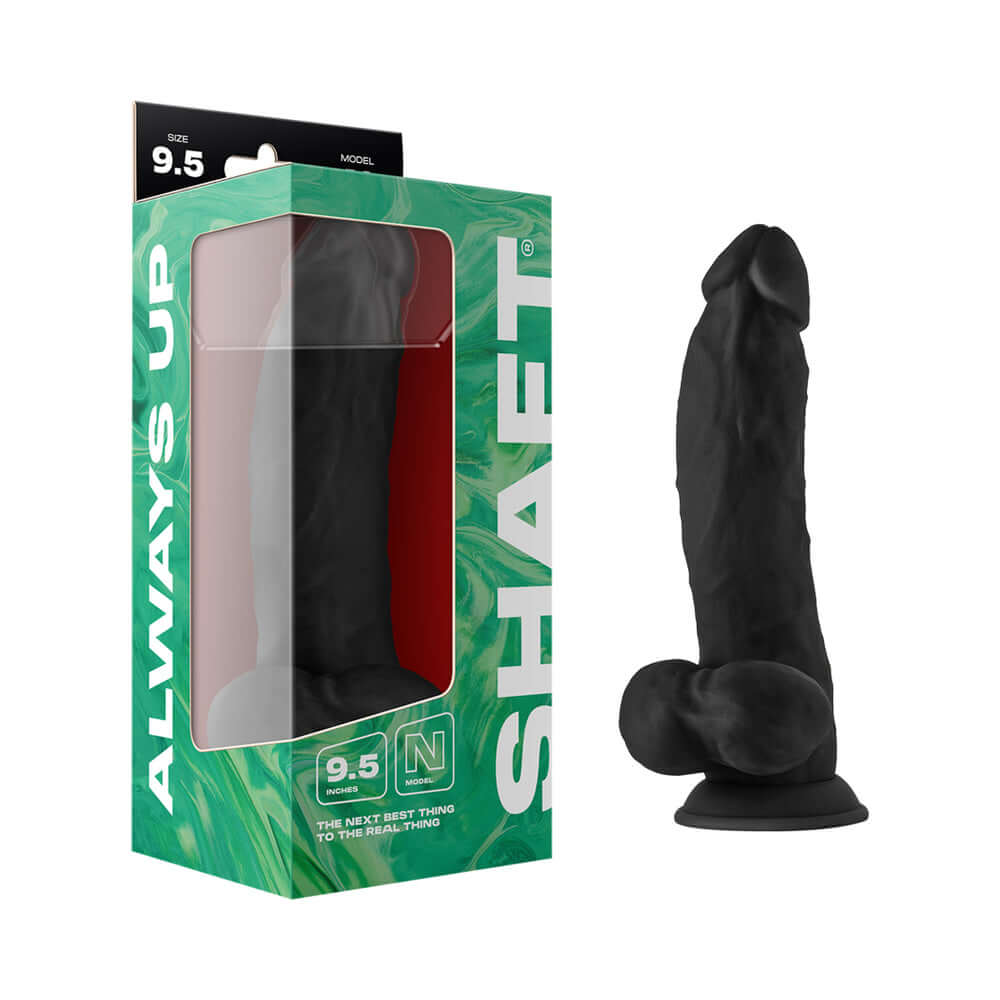 Shaft Model N 9.5 inches Liquid Silicone Dong with Balls Black in packaging on a display.