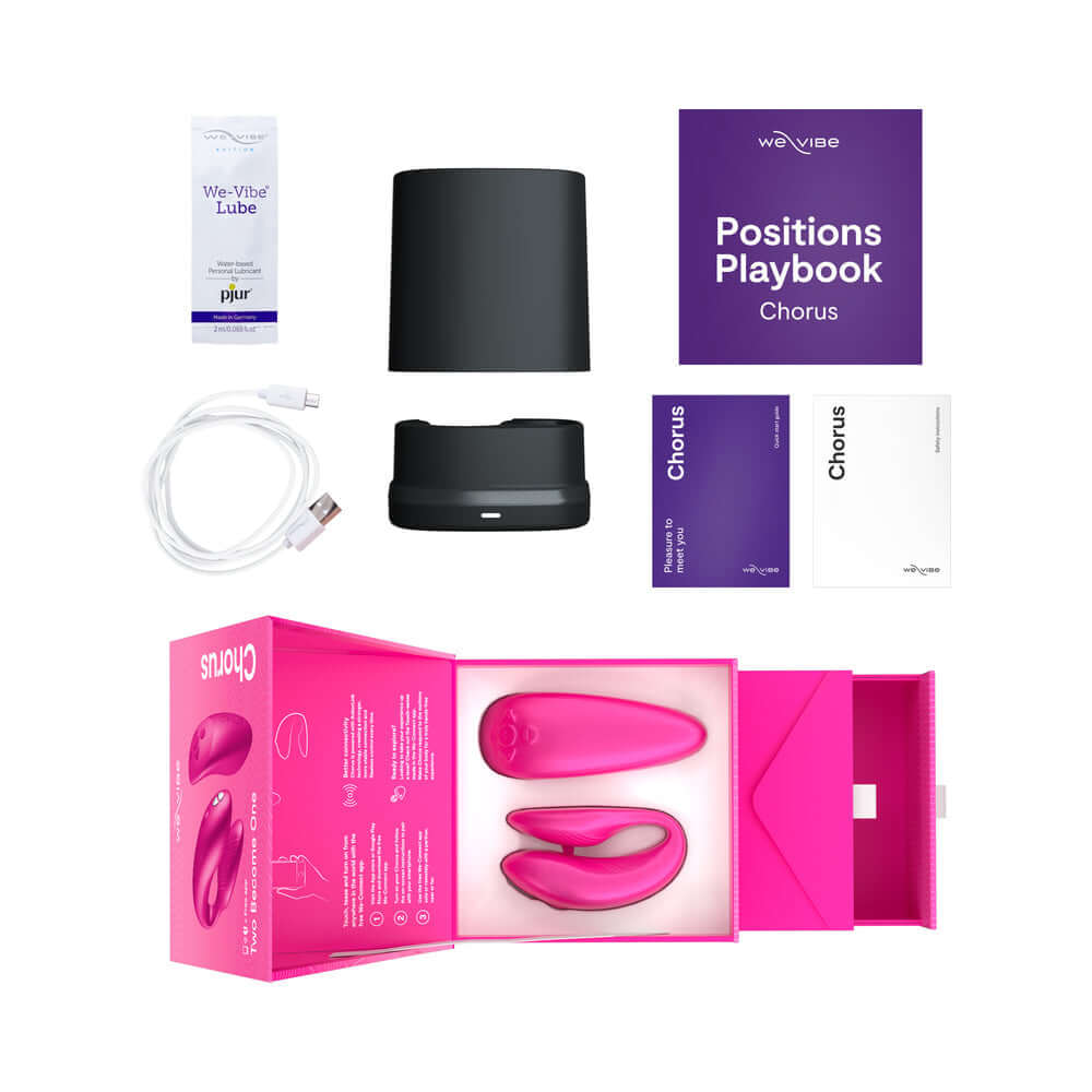 We-Vibe Chorus Couples Vibrator Cosmic Pink with accessories including lube, positions playbook, and charging cable.