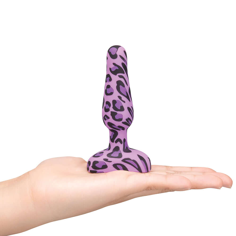 b-Vibe Novice Butt Plug Leopard is a beginner-friendly anal toy showcased in a hand.