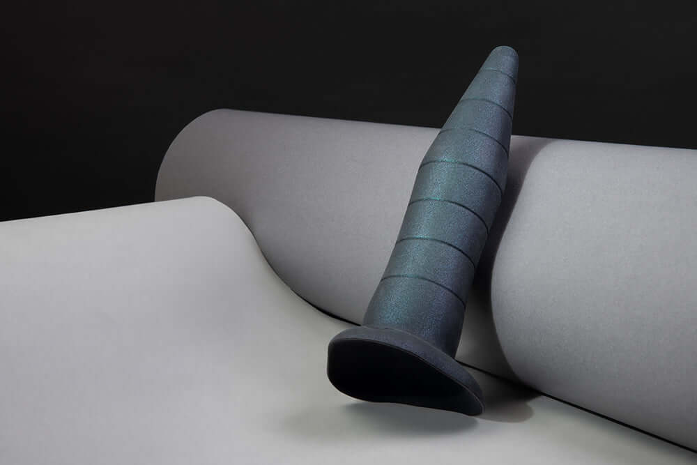 b-Vibe Fisting Anal Trainer on smooth grey background, showcasing its tapered and graduated design.