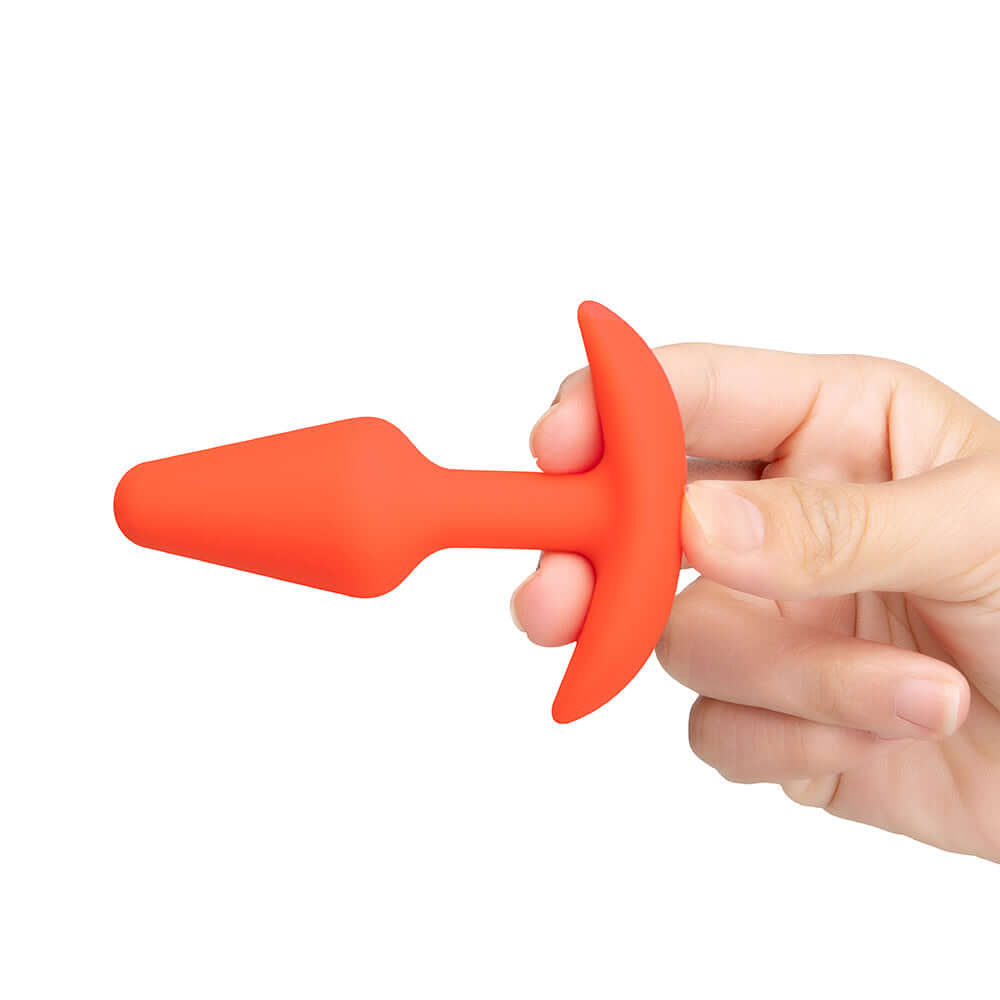 b-Vibe Butties Anal Training 2-Piece Set smaller silicone plug held in hand for comfortable anal play.