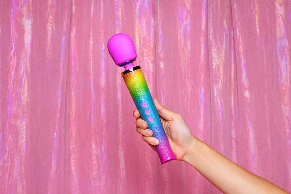 Le Wand Petite All That Glimmers Ombre handheld massager with vibrant rainbow ombre finish.
