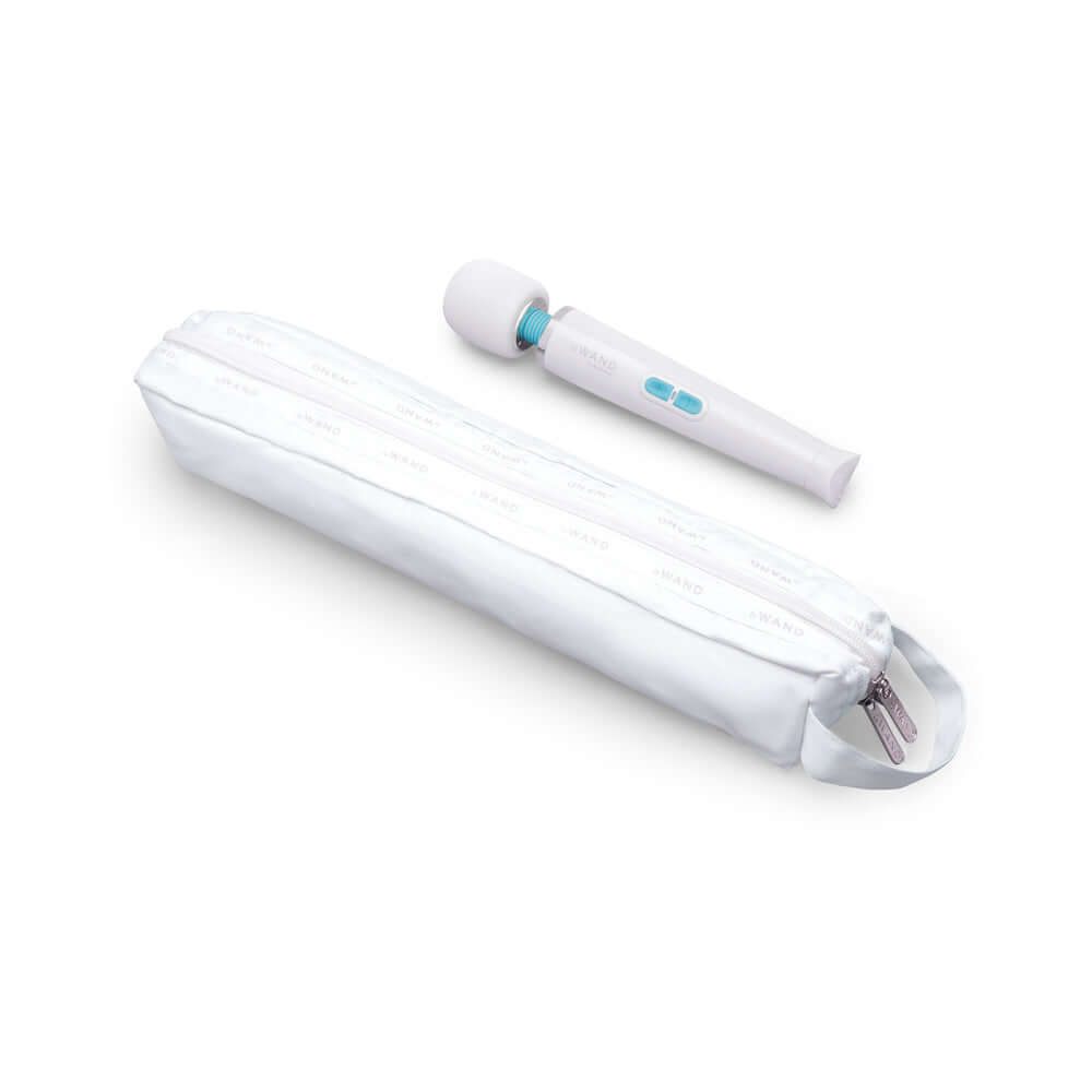 Le Wand Classique Petite Wand Massager next to its sleek carrying case, designed for relaxation and portability.