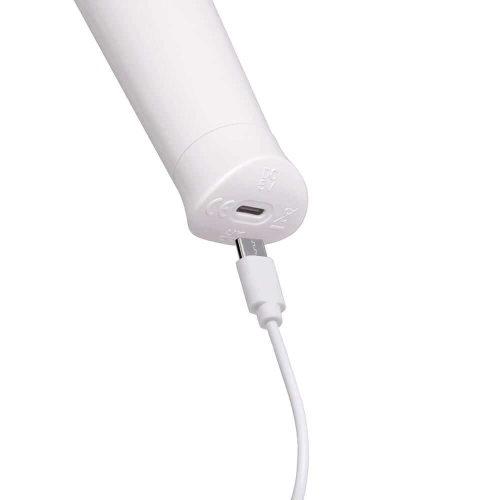 Le Wand Classique Petite Wand Massager charging port with USB cable connected for recharging.