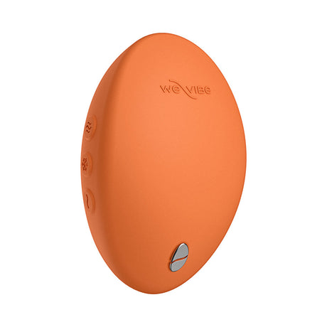 We-Vibe Temp Clitoral Massager Tangerine side view showing ergonomic design and control buttons.