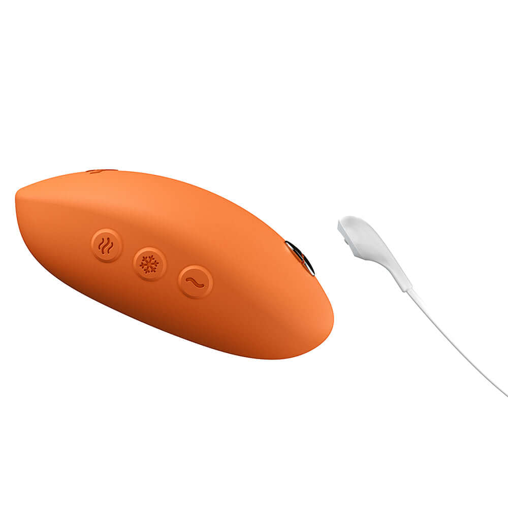 We-Vibe Temp Clitoral Massager Tangerine with temperature control buttons and charging cord.