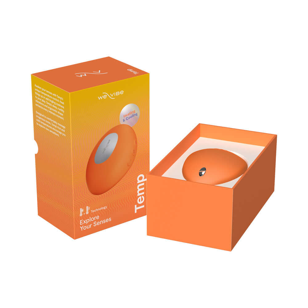 We-Vibe Temp Clitoral Massager Tangerine in its packaging, showcasing the innovative design and vibrant color.