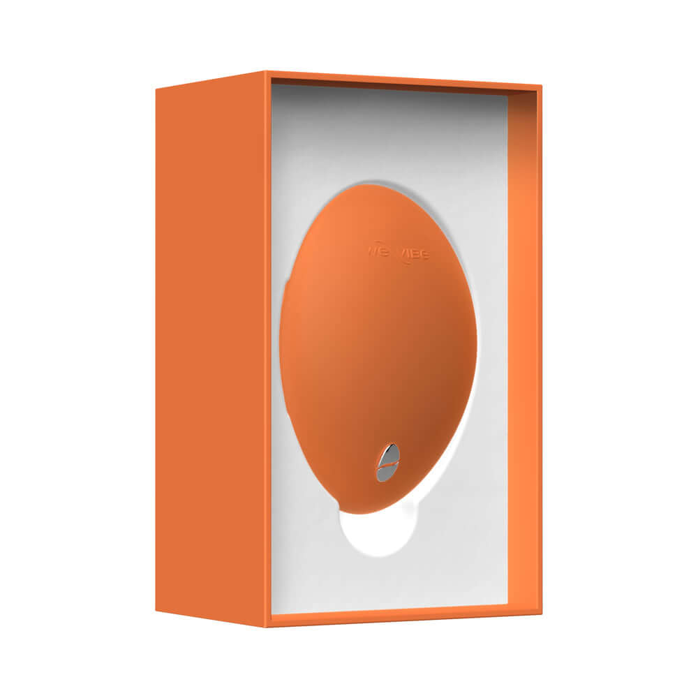 We-Vibe Temp Clitoral Massager Tangerine in its orange packaging, showcasing its ergonomic design and quality.