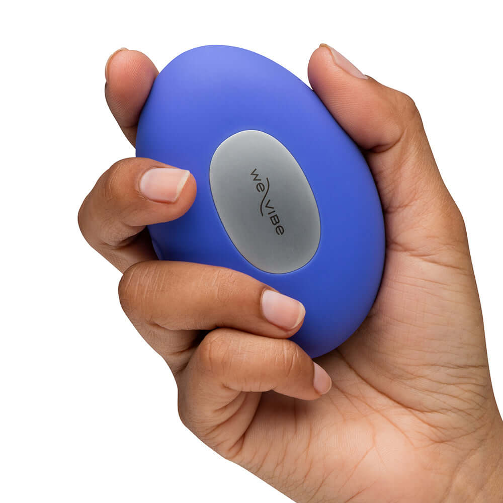 We-Vibe Temp Clitoral Massager Lavender Blue held in hand, showcasing its ergonomic design and color.