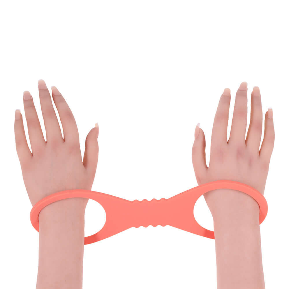 Sportsheets Sex & Mischief Peaches n CreaMe Large Silicone Cuffs shown on wrists for playful restraint and comfort.