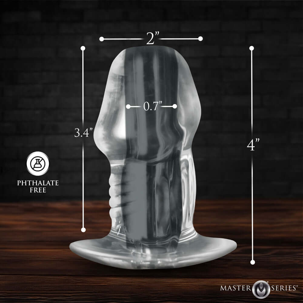 Master Series Dicked Clear Hollow Anal Plug Medium with dimensions on a wooden background, phthalate free.