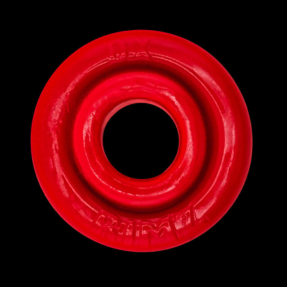 Oxballs Rimz Single Ring Red displayed on a black background, highlighting its flexible design and vibrant color.