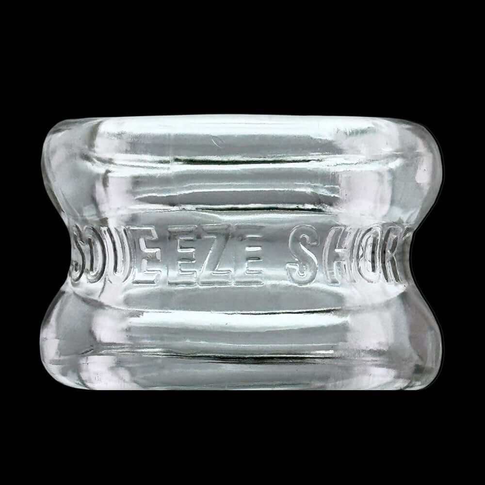 Oxballs Squeeze Short Ballstretcher Clear, featuring a compact hourglass design for comfortable use.
