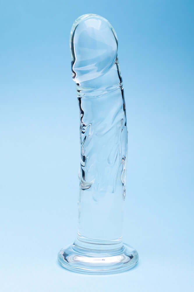 Clarity Seraphic Rapture Glass Dildo displayed against a blue background, showcasing its clear handblown design.