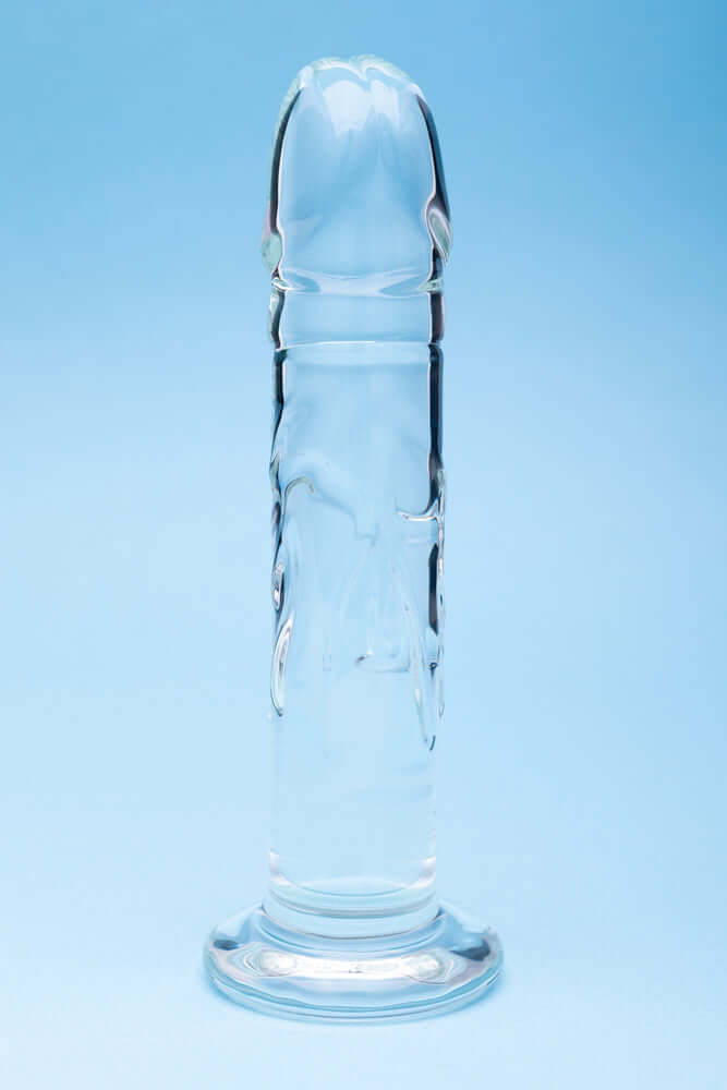 Clarity Seraphic Rapture Glass Dildo showcased against a blue background, highlighting its sleek design and craftsmanship.