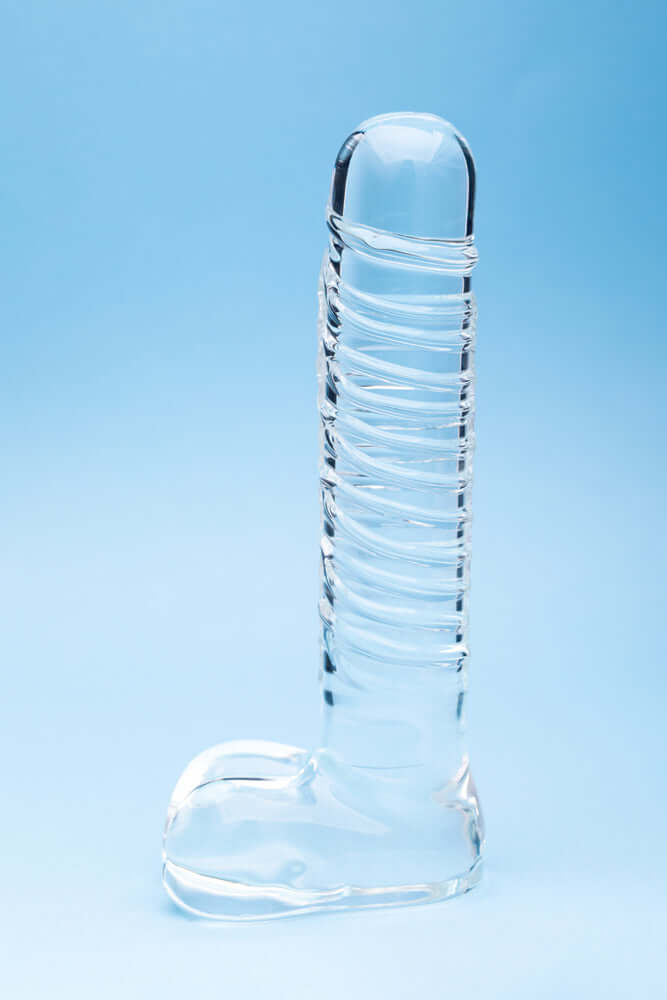 Clarity Seraphic Opus Glass Dildo displayed on a blue background, showcasing its elegant design and craftsmanship.