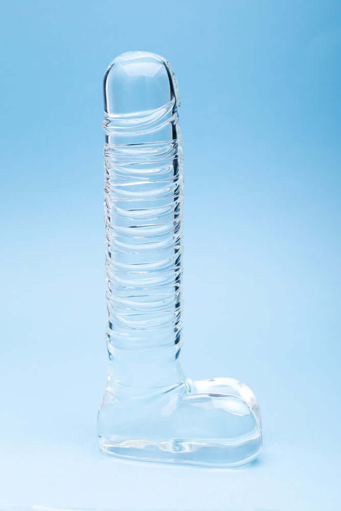Clarity Seraphic Opus Glass Dildo on a blue background, showcasing its elegant design and handblown craftsmanship.