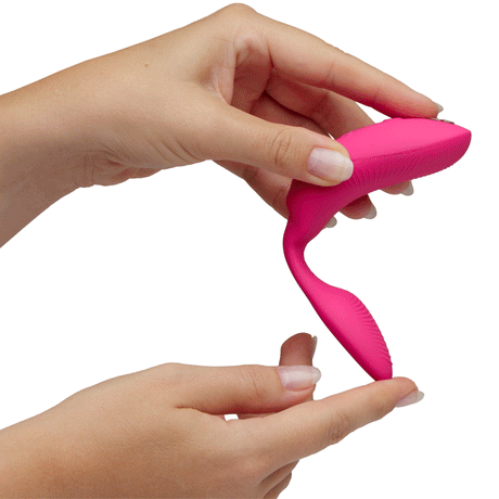 We-Vibe Chorus Pro Couples Massager Electric Pink being held in hands for demonstration.