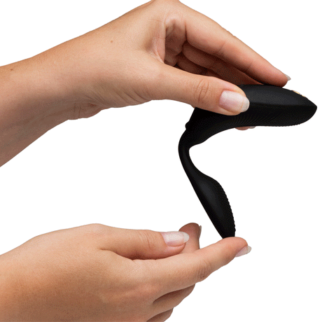 We-Vibe Chorus Couples Vibrator with Remote Control Black held in hands, showcasing its sleek design.