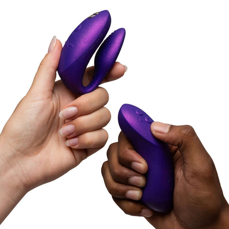 Hands holding the We-Vibe Chorus Pro Cosmic Purple couples' vibrator showcasing its unique design.