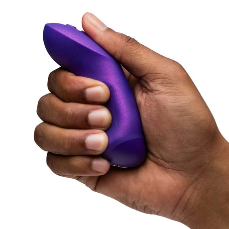 Person holding the We-Vibe Chorus Pro Cosmic Purple couples' vibrator in their hand.