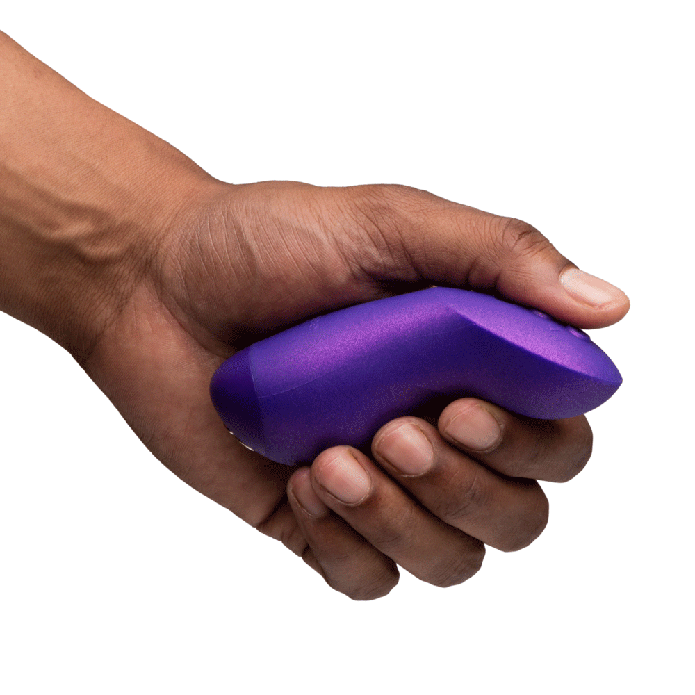 We-Vibe Chorus Pro Cosmic Purple held in a hand, showcasing its ergonomic design and vibrant color.