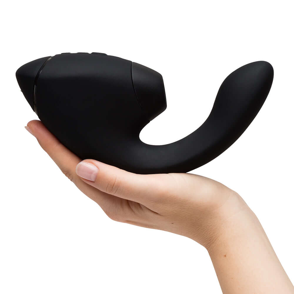 Womanizer Next Duo Massager Black held in hand, showcasing its ergonomic design and advanced stimulation features.