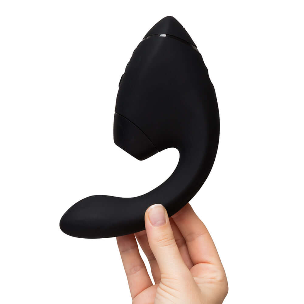 Womanizer Next Duo Massager Black held in hand showcasing its sleek design and dual stimulation features.