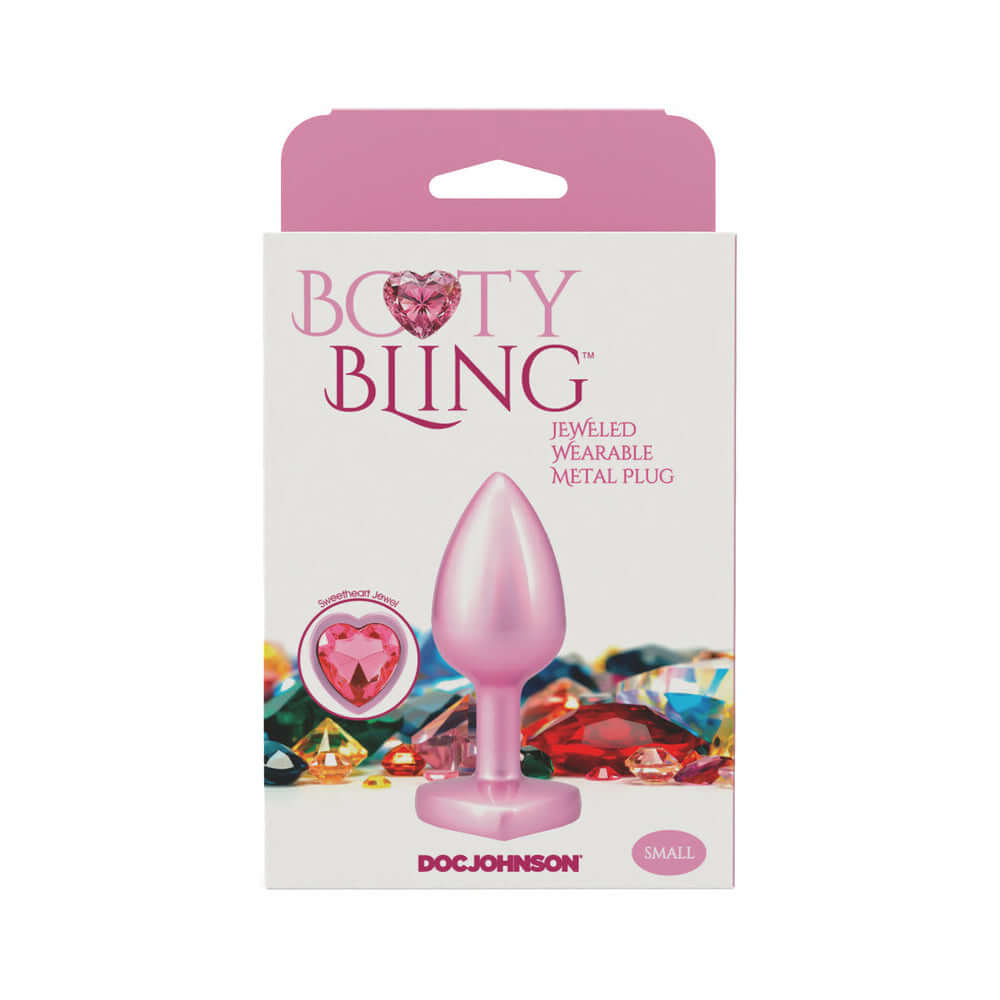 Booty Bling Heart Diamond Jeweled Metal Plug Pink Small in packaging with colorful background.
