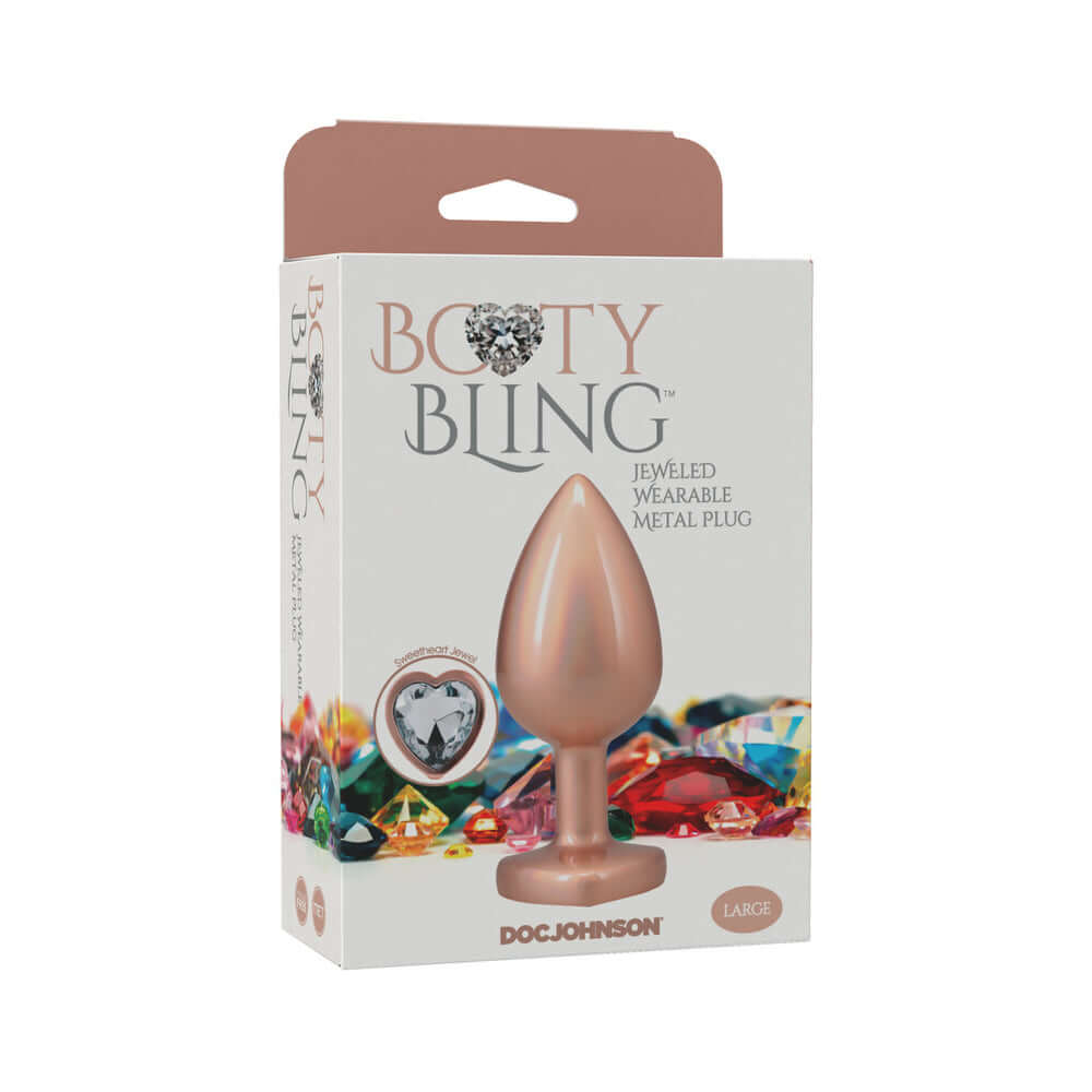 Booty Bling Heart Diamond Jeweled Metal Plug Gold Large packaging with decoration and colorful gems in the background.