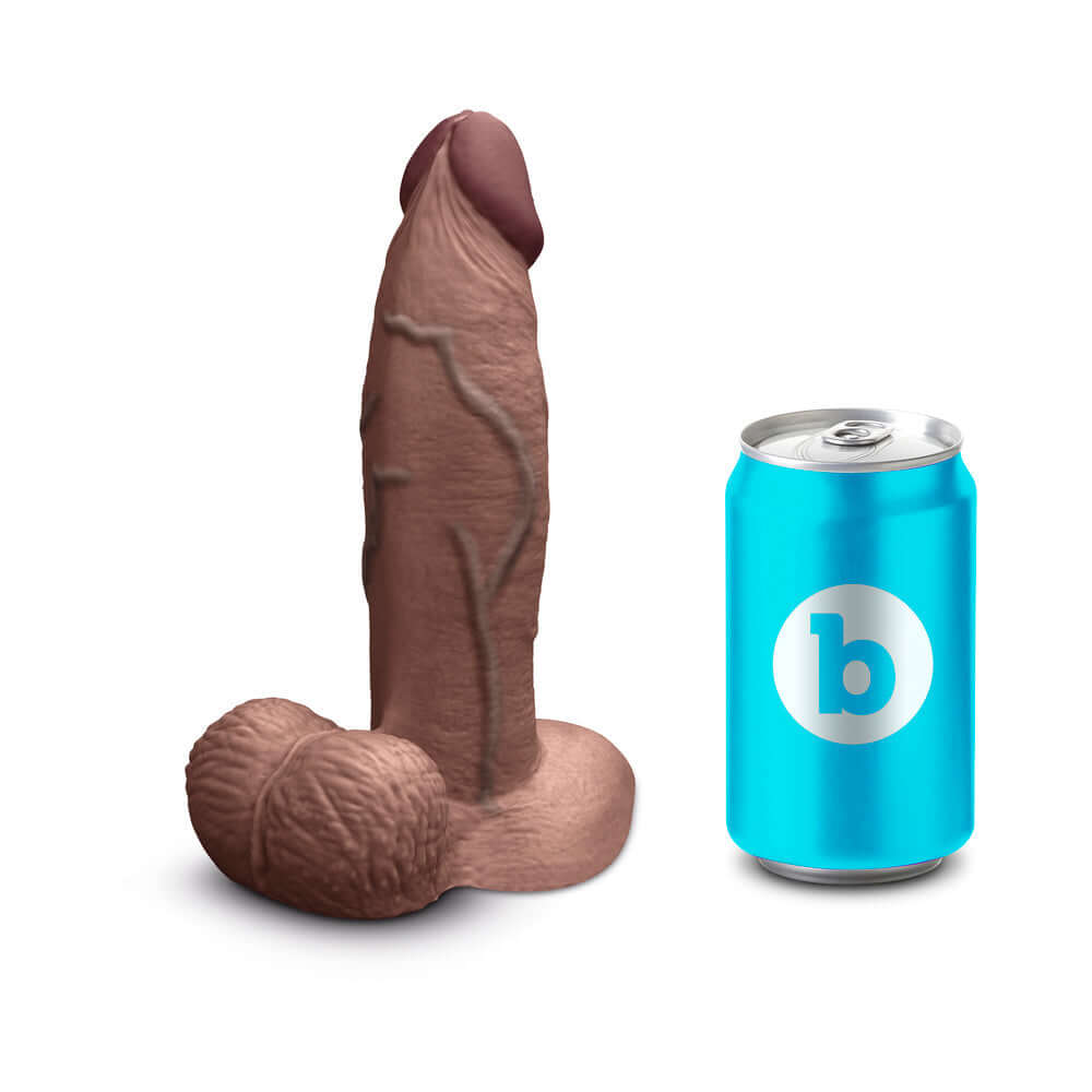 b-Vibe Slipskin Realistic Silicone Dildo 7 inch Girthy Brown next to a can for scale.