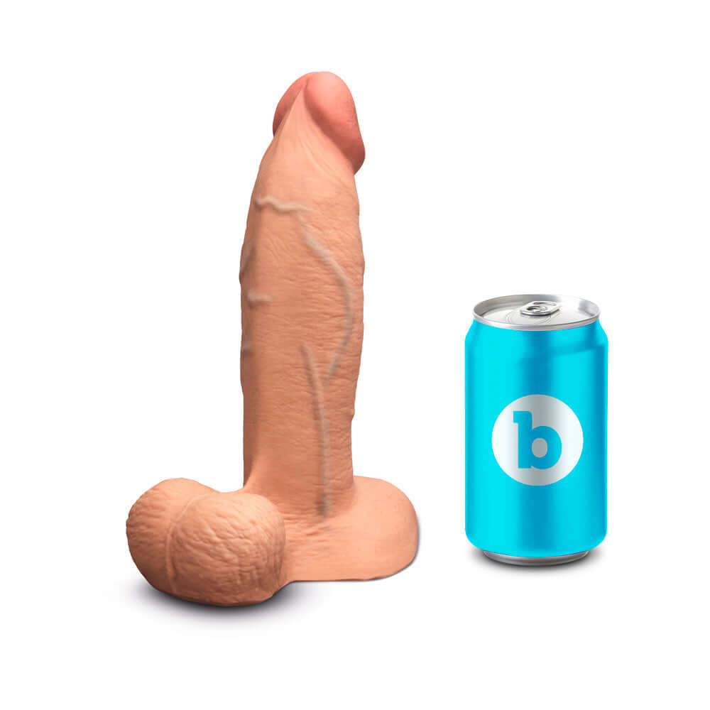 b-Vibe Slipskin Realistic Silicone Dildo 8 inch Girthy Mocha alongside a standard-sized can for scale.