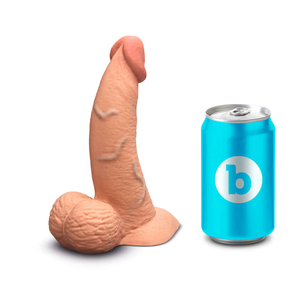b-Vibe Slipskin Realistic Silicone Dildo 6.5 inch Curved Mocha next to a can for scale