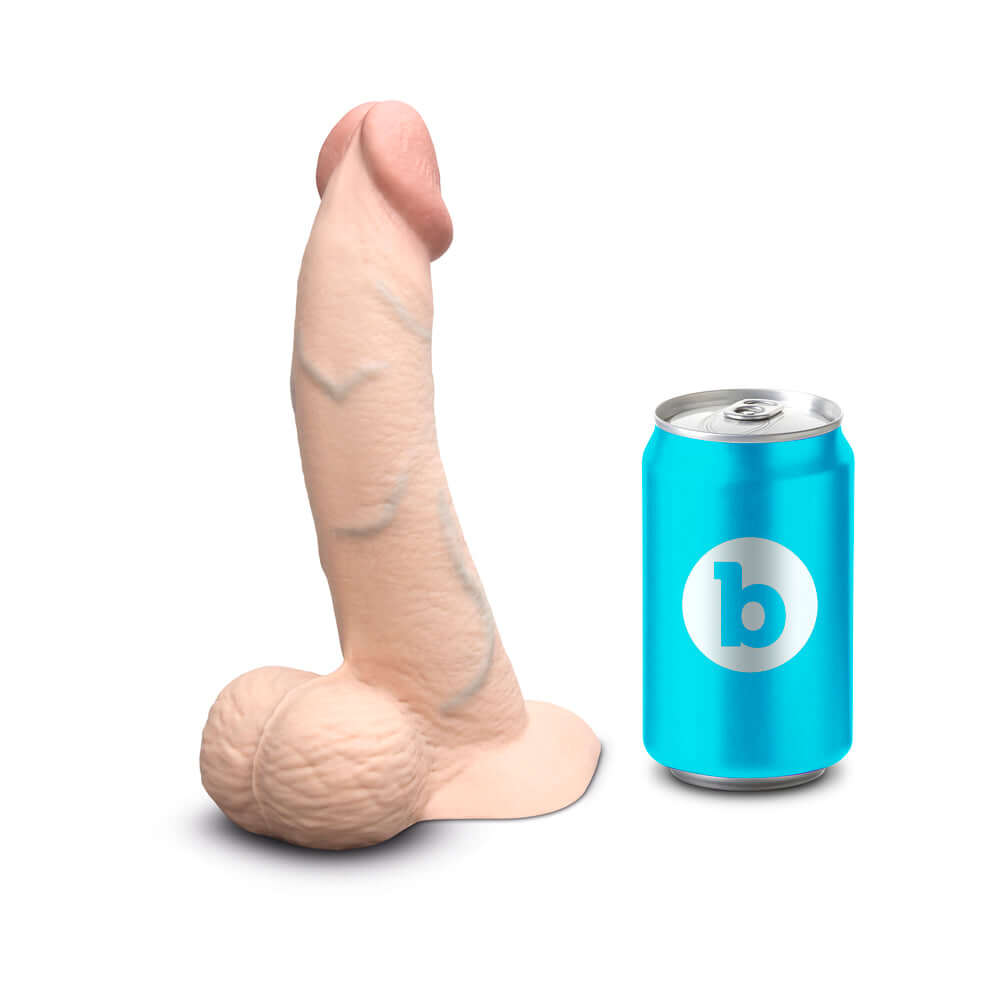 b-Vibe Slipskin Realistic Silicone Dildo 8 inch Curved Cream next to a drink can for size comparison.