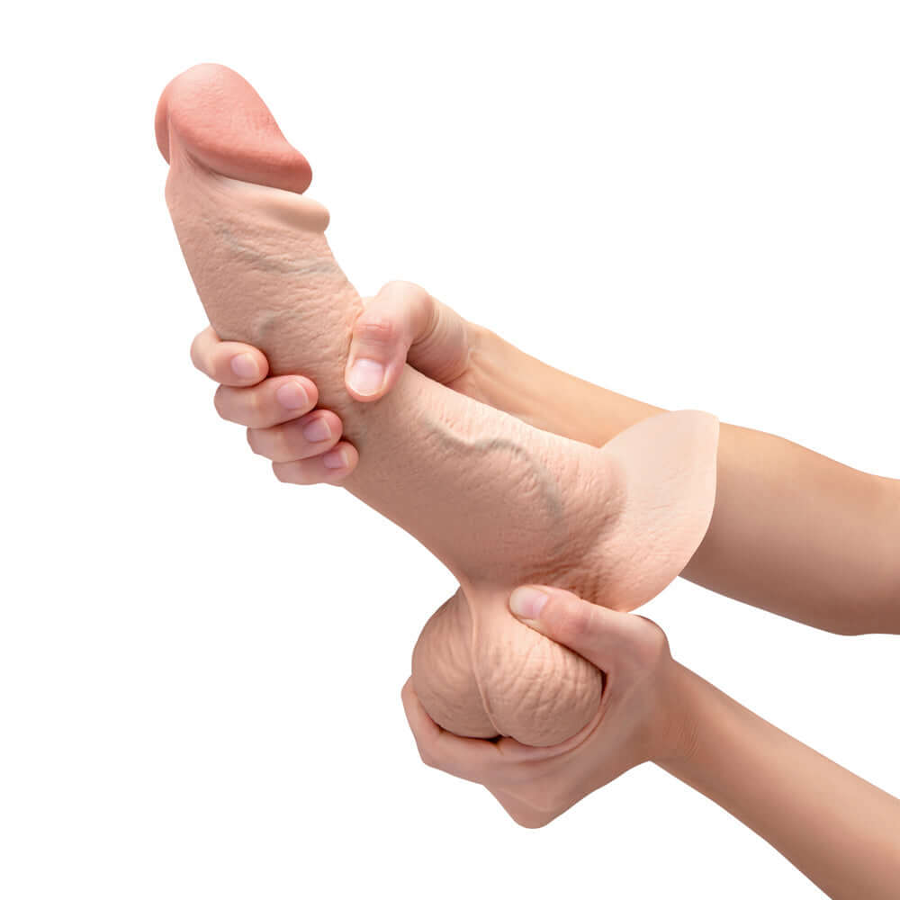 b-Vibe Slipskin Realistic Silicone Dildo 10 inch Curved Cream held in hands, showcasing its lifelike design.