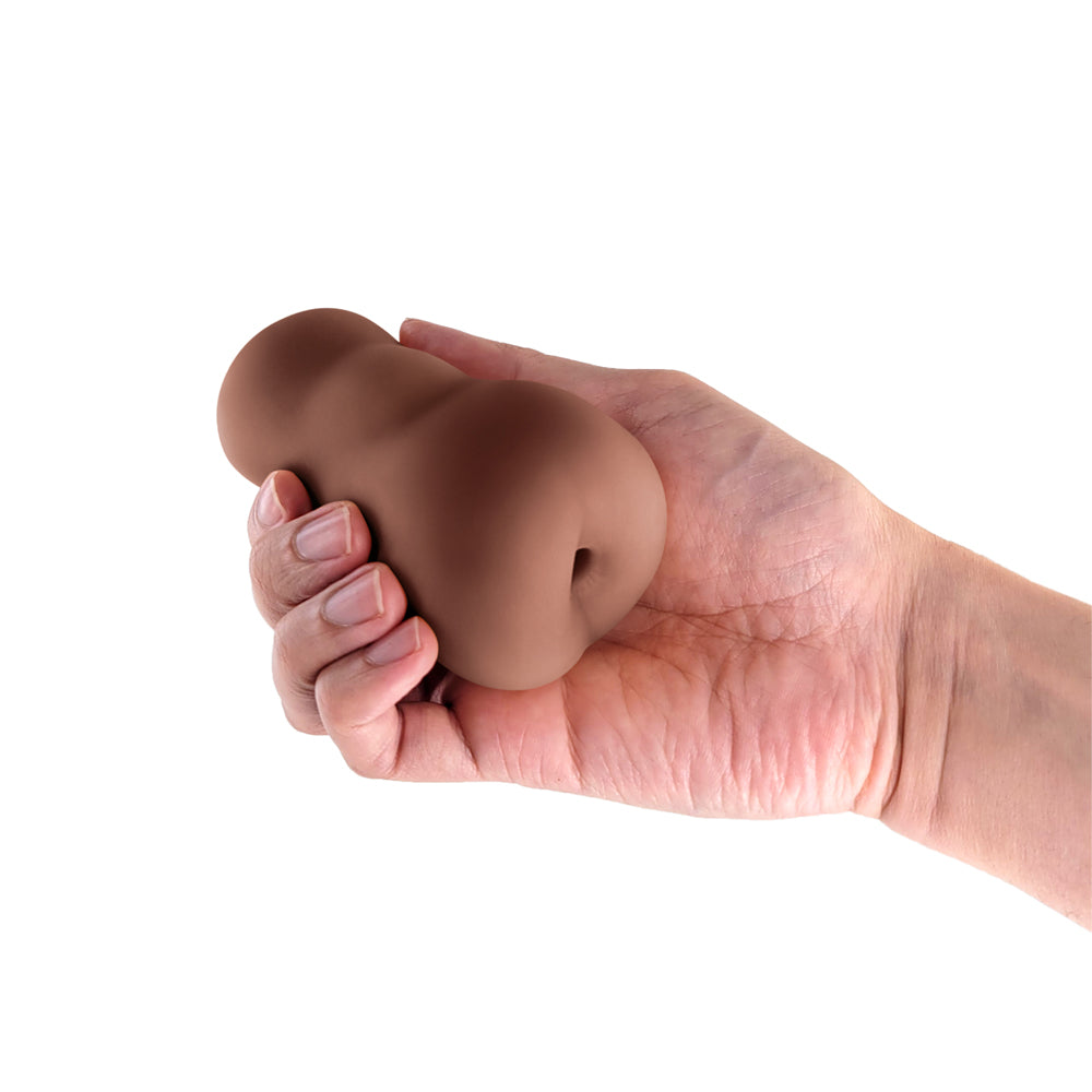 Pocket Pals Anal Stroker Brown held in a hand, showcasing its compact and lifelike design for intense pleasure.