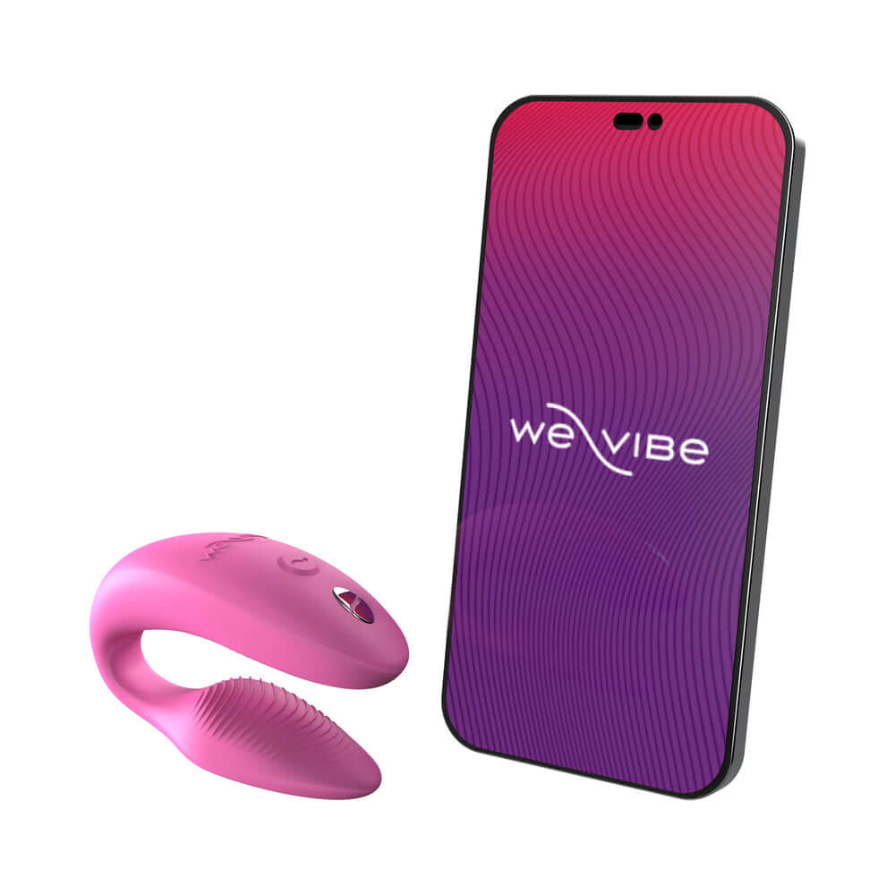 We-Vibe Sync 2 Remote Control Couples Vibrator Rose next to a smartphone with We-Vibe branding.