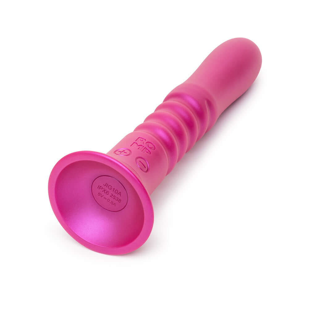 Romp Jiggle Thrusting Vibrator Pink shown in a close-up view, highlighting its ergonomic design and suction cup base.