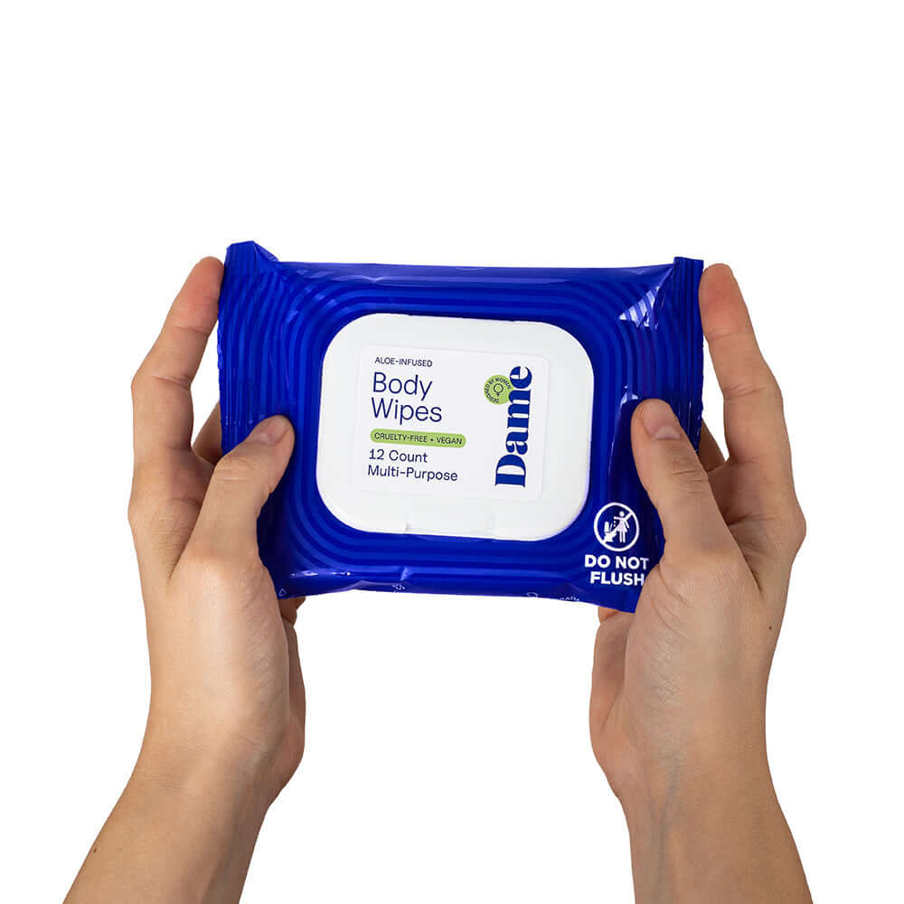 Dame Body Wipes 12 count Aloe & Cucumber packaging held in hands, showcasing gentle cleansing wipes.