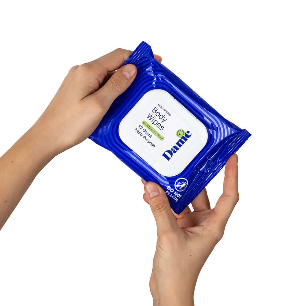 Dame Body Wipes 12 count Aloe & Cucumber packaging held in hands, showcasing gentle cleansing wipes.