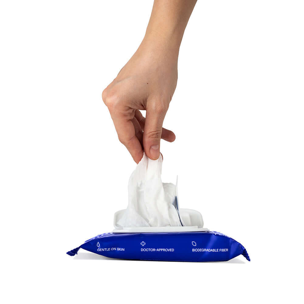 Dame Body Wipes 12 count Aloe & Cucumber being pulled from the package for gentle cleansing.
