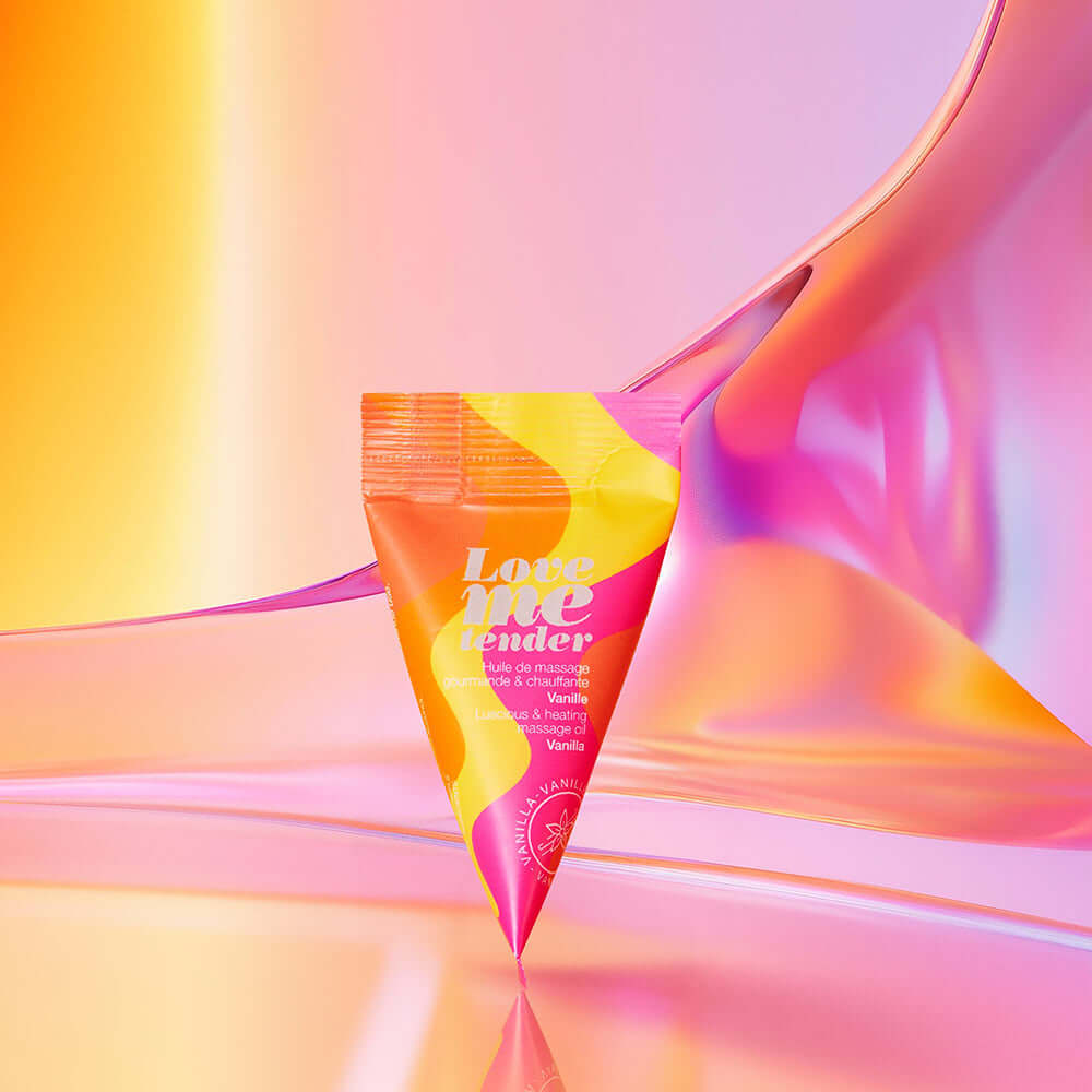 Love To Love Love Me Tender Heating Massage Oil Vanilla packaging against a colorful gradient background.