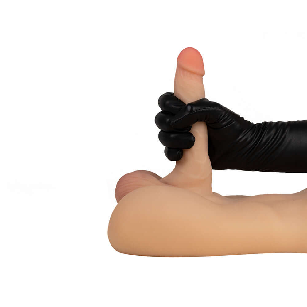 Hand holding the flexible dildo of the Camtoyz Raw Realistic Torso Draven with realistic detailing.